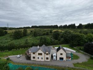 an aerial view of a house in a field at Doura Lodge in Inverness