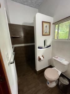 a small bathroom with a toilet and a staircase at Darwin's temple in San Cristobal