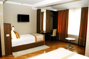Ένα ή περισσότερα κρεβάτια σε δωμάτιο στο Hotel Elegance