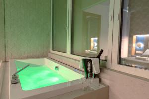 a bathroom sink with a bottle and glasses on it at Al Chiar di Luna in Monte di Procida