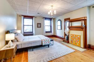 a bedroom with a bed and a fireplace at Spacious Pittsburgh Rental Walk to Frick Park! in Pittsburgh