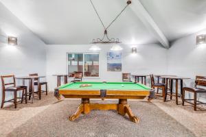 a pool table in a room with tables and chairs at Giant Steps #38 in Brian Head