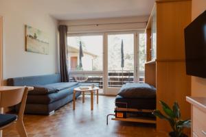 a living room with a couch and a table at Pool House Merano in Merano
