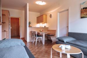 a living room with a couch and a table at Pool House Merano in Merano