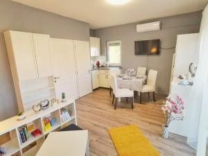 a living room with a table and a kitchen at Panoráma Garden in Zalakaros