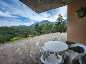 a white table and chairs on a balcony with a view at B&B Greppe68 in Porretta Terme