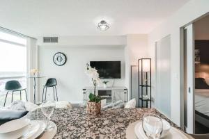 a living room with a table with wine glasses at Beautiful 1BD 1BA Condo Lake and City Views in Toronto