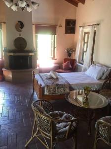 a bedroom with a bed and a table and chairs at Traditional village house on Argolis for 6 persons in Kariá