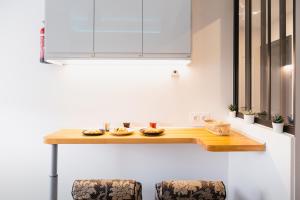 a kitchen with a counter with some food on it at Sublime 3 Rooms Showers in Colombes