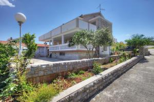 a building with a retaining wall in front of it at Apartments Irena in Jezera