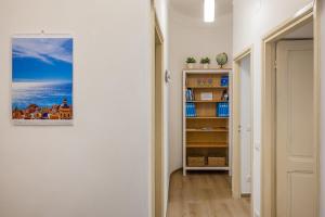 a hallway with a book shelf with books at Casa Castelletto in Finale Ligure