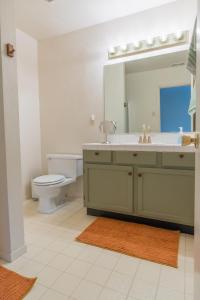 a bathroom with a sink and a toilet and a mirror at Sweet Arnold Cabin in Arnold