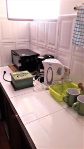 a kitchen counter with a toaster and cups on it at Historic Centre Premium Quality Lodging in Quito