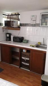 a kitchen with a sink and a counter top at Historic Centre Premium Quality Lodging in Quito