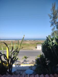 a view of the beach from a house with plants at Apartamentos Águia Azul Flat Andar Superior in Ilha Comprida