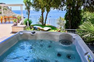 a jacuzzi tub with a view of the ocean at Paradisea Taormina in Taormina