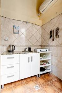 a kitchen with white cabinets and a sink at Dante y compañía in Buenos Aires