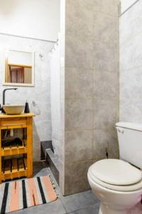 a bathroom with a toilet and a sink at Dante y compañía in Buenos Aires