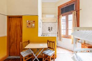 Habitación con mesa, sillas y cama en Dante y compañía en Buenos Aires