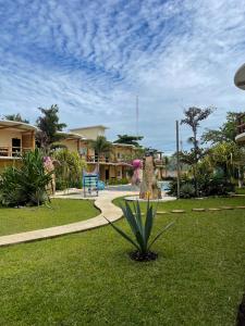 a park with a plant in the grass at Hotel Pazifico en Monterrico in Monterrico