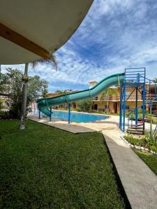 a water slide in a swimming pool at Hotel Pazifico en Monterrico in Monterrico +19 photos