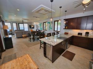 a large kitchen and living room with a dining room at Eagle Ray in Gibson Bight