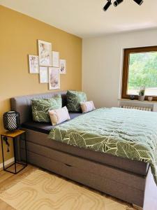a bedroom with a large bed with a couch at Landliebe in Schonungen