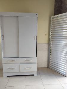 a white dresser with a mirror in a room at Condomínio DINASEG in Rio Branco