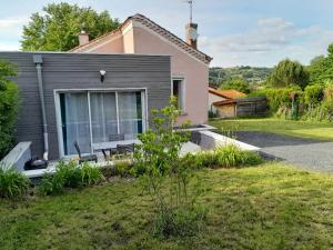 a small house with a garden in front of it at Le Chantoiseau in Unieux