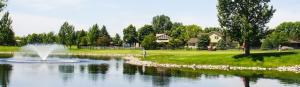 a fountain in the middle of a pond in a park at Delta Hotels by Marriott Fargo in Fargo