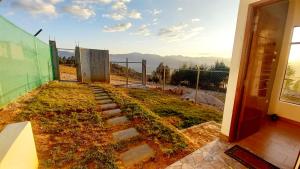 a view of a garden from a house at Casa de Campo Mirador de la Retama in Cajamarca