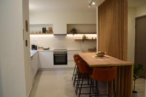 a kitchen with a wooden table and chairs at Downtown Delight in Chania Town +17 photos