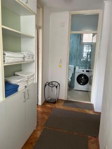a bathroom with a laundry room with a washing machine at Apartment Centropolis in Mostar