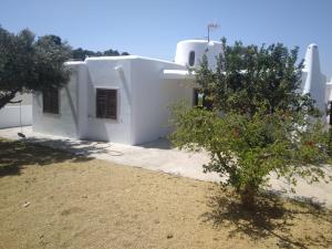 uma casa branca com uma árvore em frente em Rentaly Holidays Playa Villaricos em Cuevas del Almanzora