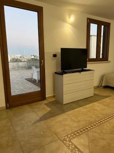 A television and/or entertainment centre at FH HOLIDAYS SALENTO