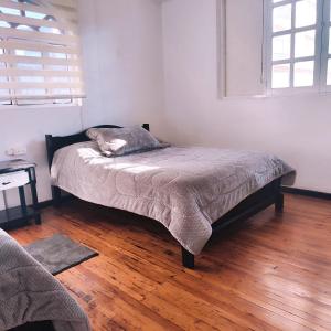 Postel nebo postele na pokoji v ubytování Hotel Muros Quito