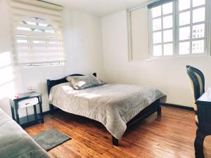 Postel nebo postele na pokoji v ubytování Hotel Muros Quito