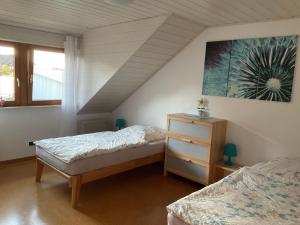 ein Schlafzimmer mit 2 Betten und einem Wandgemälde in der Unterkunft Ferienwohnung Lösch in Neuenburg am Rhein