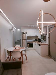 a kitchen and dining room with a table and chairs at Alpha Villas in Gennadi