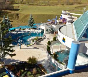 a view of a water park with a swimming pool at Matterhof in Leukerbad