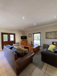 un salon avec un canapé et une table dans l'établissement @Leisure Guest Suite, à Stellenbosch