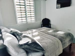 Postel nebo postele na pokoji v ubytování Hotel Muros Quito