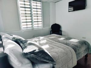 Postel nebo postele na pokoji v ubytování Hotel Muros Quito