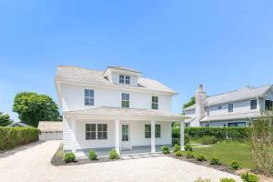 a white house with a driveway at Charming 7-Bedroom Southampton Compound in Southampton