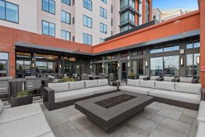 a patio with couches and tables in a building at Residence Inn by Marriott Atlanta Covington in Covington