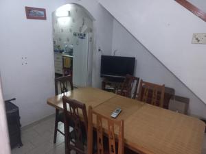 a dining room with a table and a television at La Lucila del Mar in Costa Azul