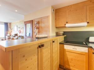 a kitchen with wooden cabinets and a counter top at Appartement Avoriaz, 4 pièces, 6 personnes - FR-1-314-195 in Morzine