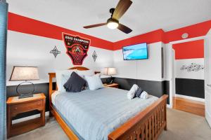 a bedroom with a bed with a baseball team on the wall at Sports Themed--Automated King Bed--Family Friendly--5 miles to Strip in Las Vegas