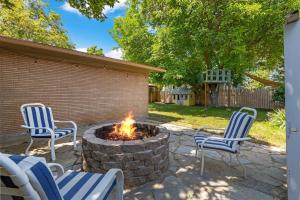 a patio with two chairs and a fire pit at 1950s Charmer in Boise