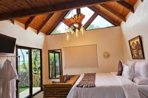 a bedroom with a bed and a large window at Hotel Casa Realeza in Antigua Guatemala